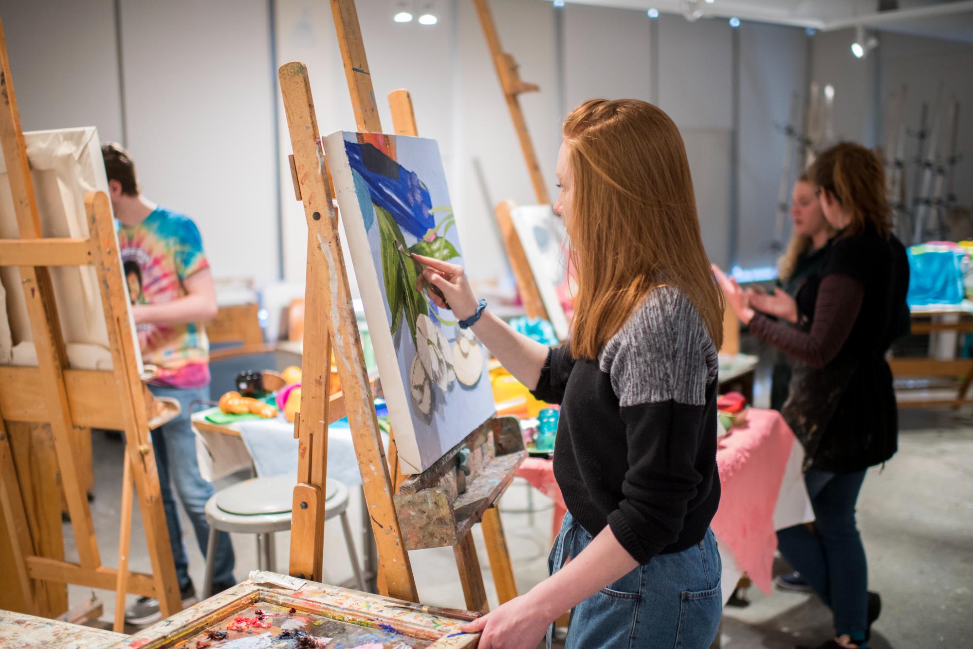 Students painting on easels